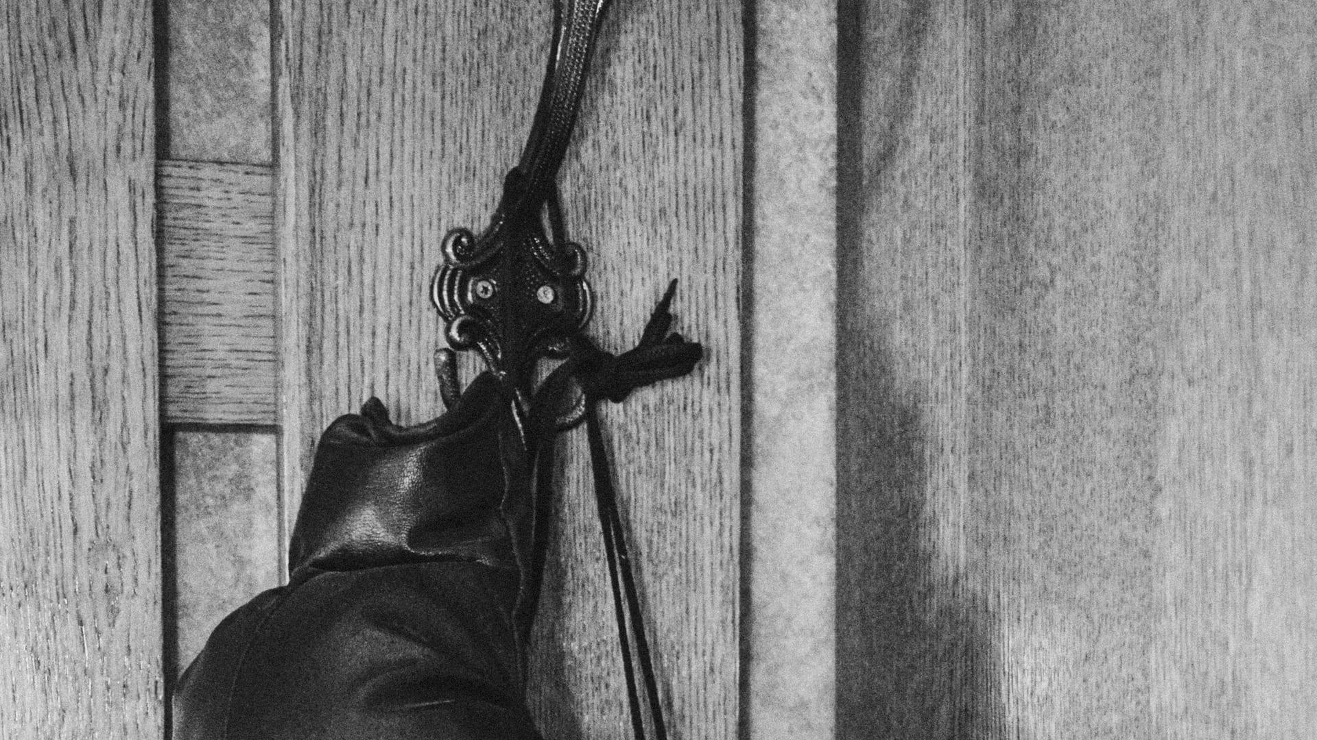 A pair of worn boxing gloves hanging on a wall